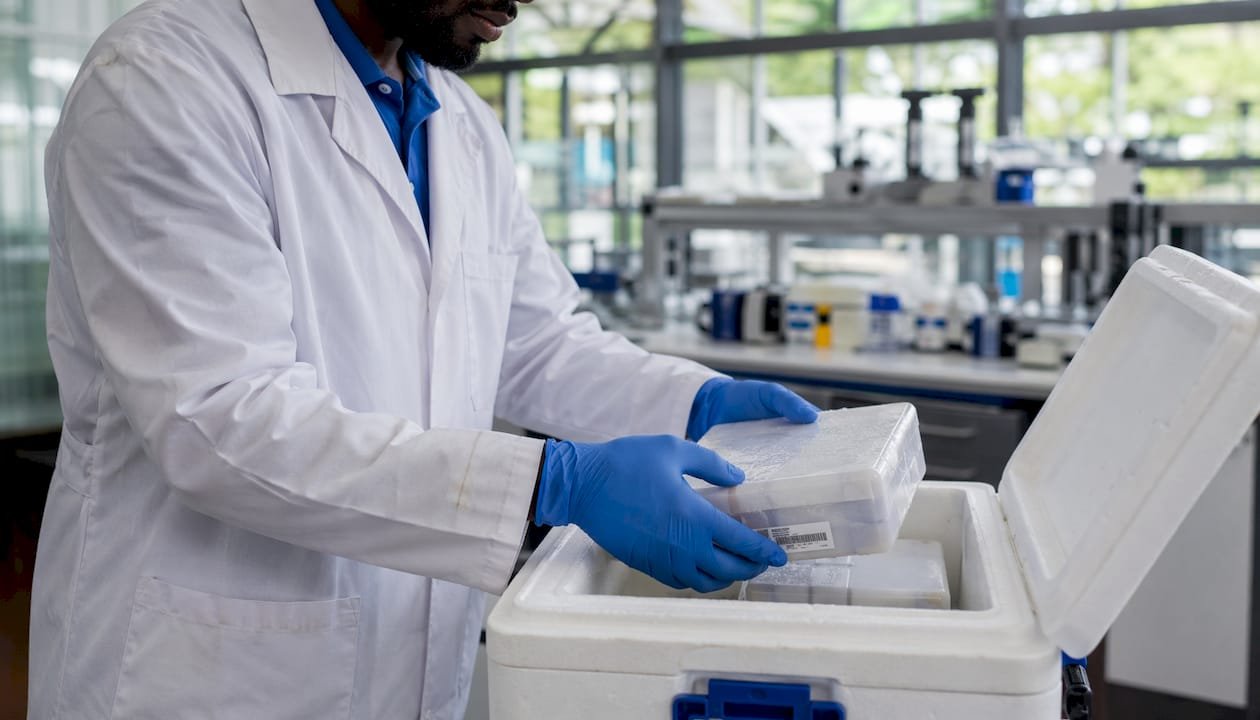 Scientist unpacking refrigerated PCR reagents
